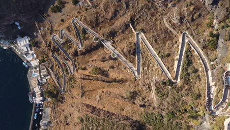 Top-View-over-Zig-Zag-Stairs-from-Old-Harbor-up-to-Fira-Capital-Center,-Santorini,-Greece