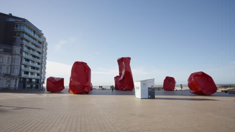 red sculptures of artist arne quinze at the sea wall in ostend, belgium - beaufort sculpture park