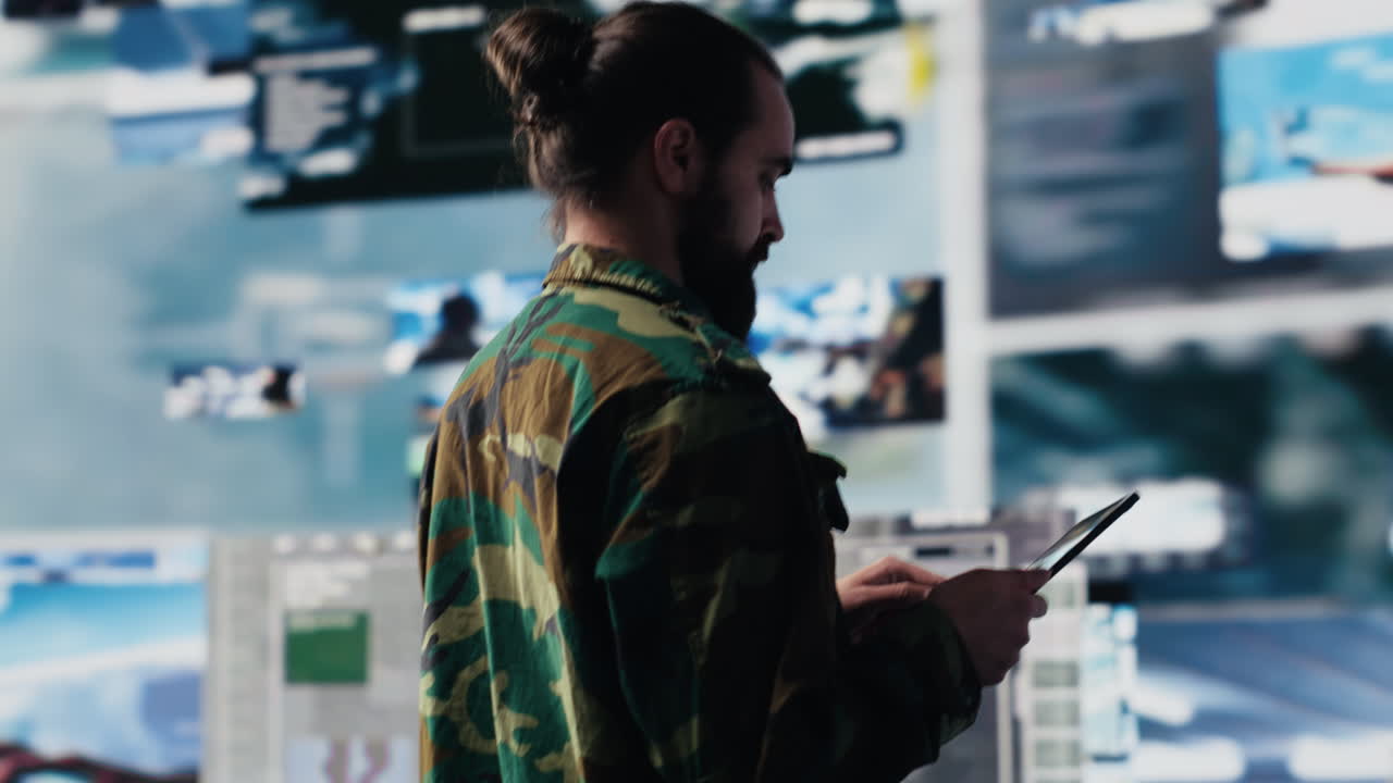 Armed forces officer monitoring drone and satellite imagery for intelligence