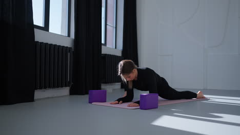 woman doing a yoga pose in a studio