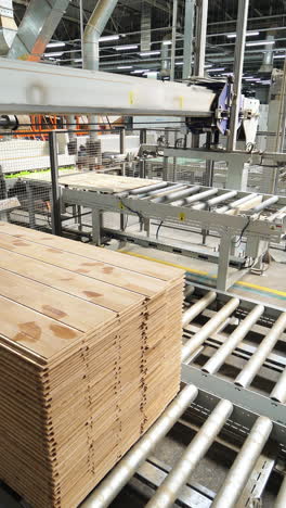 floorboard production in the industrial factory. manufacturing of a parquet board. modern technologies. vertical video
