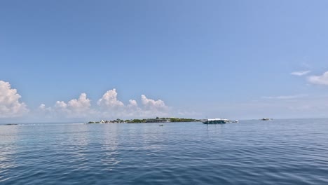 Riding-a-Bangka-Boat-with-Hilutongan-Island-at-the-Horizon-during-an-Island-Hopping-Tour-in-Mactan,-Cebu,-Philippines