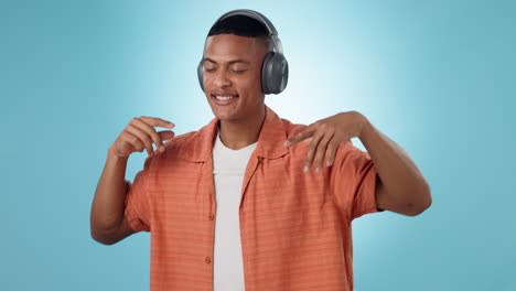 headphones, energy and young man in a studio