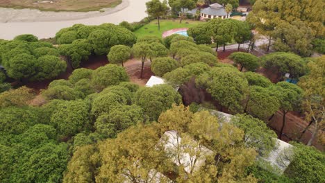 Kreisförmiger-Drohnenflug-über-Einen-Campingplatz-Mit-Zelten-Am-Fluss-In-Huelva-Im-Südwesten-Spaniens