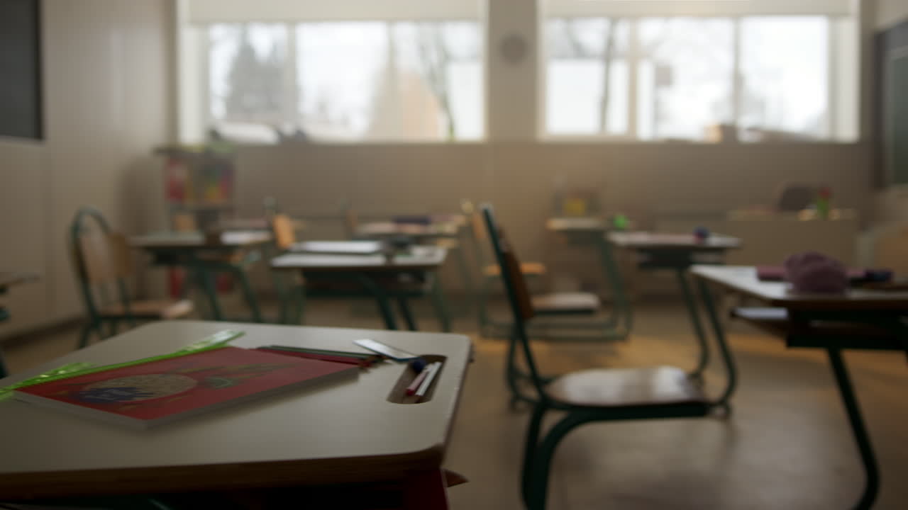 Classroom with desks and chairs. Interior of school room with chalkboard
