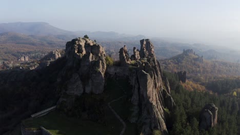 Pull-in-drone-shot-of-Belogradchik-Rock-Cliff,-a-natural-rock-sculptural-formation-in-Vidin-province-in-Northwestern-Bulgaria