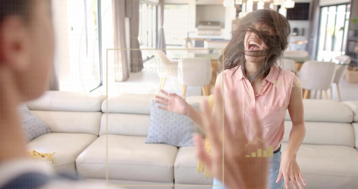 Upon hearing music older sister dancing in home interacting with data graphs and sharing high-five