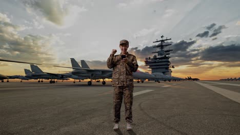 full body of asian man soldier looking at smartphone then screaming goal celebrating while standing on aircraft carrier