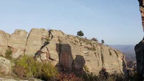 Slowly-retreating-in-a-pull-away-drone-fly-through-between-the-crags-and-boulders-of-the-Belogradchik-natural-rock-formations-in-Vidin-province-in-Northwestern-Bulgaria