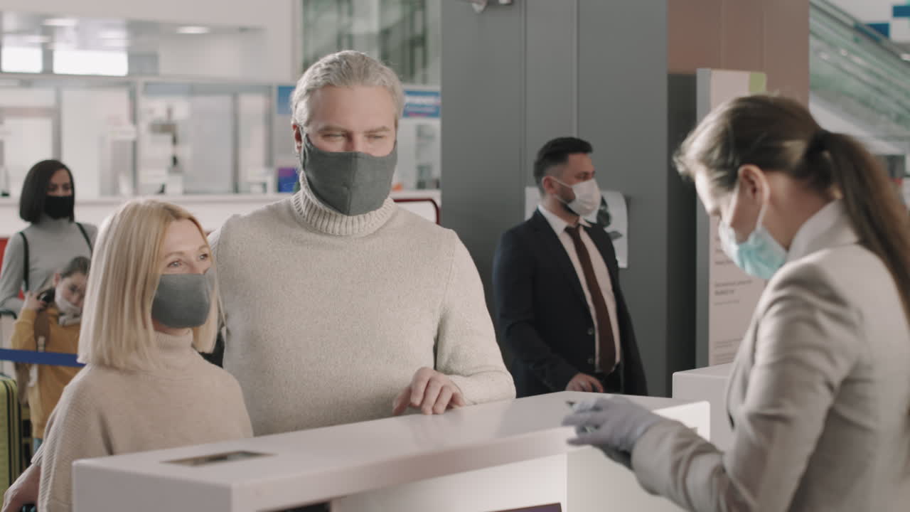 Couple Passing Passport Control In Airport