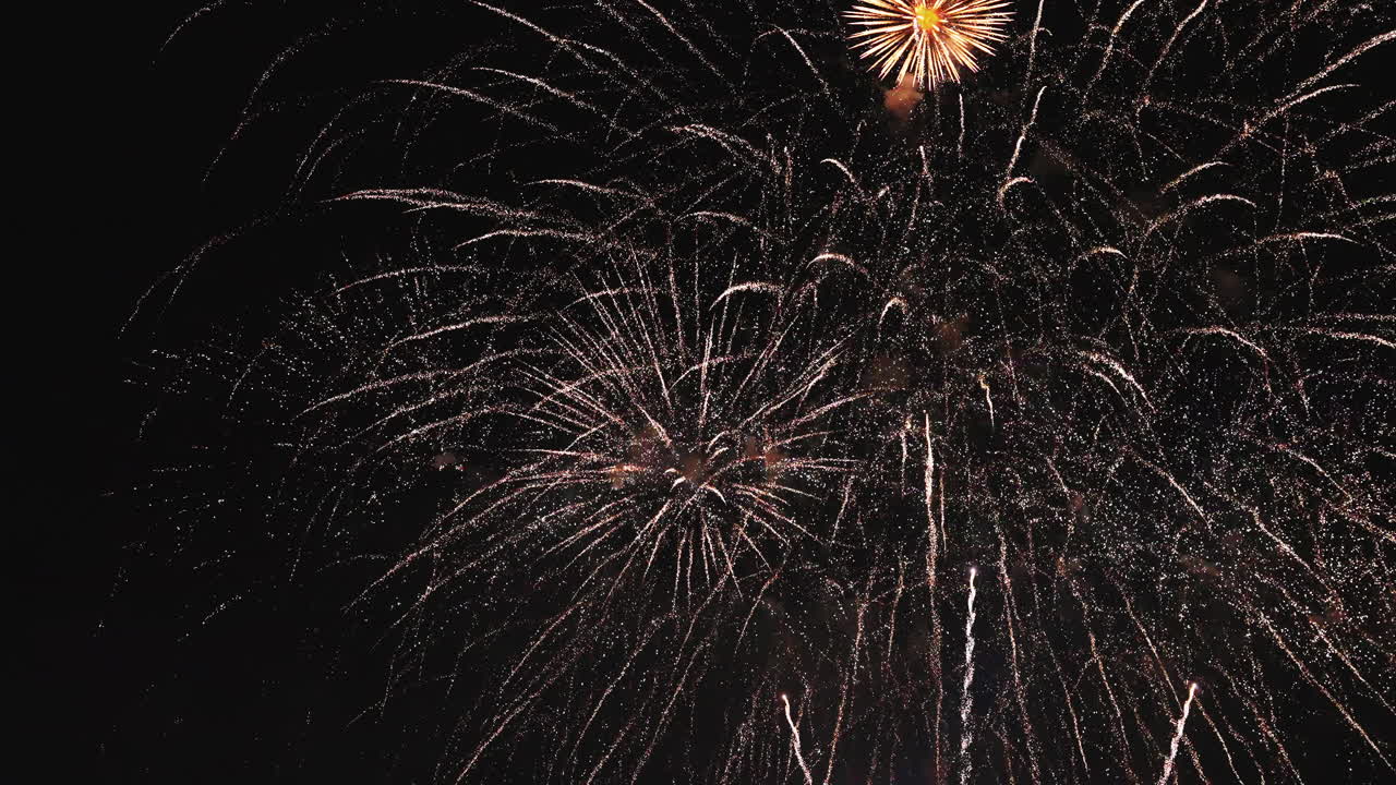 Twilight fireworks illuminating the sky with vivid colorful explosions