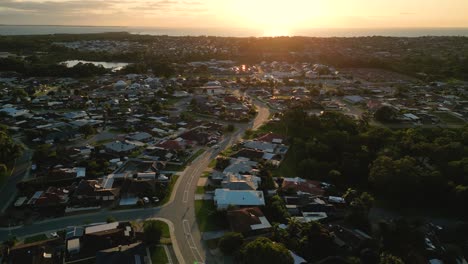 aerial view of perth coastal suburn neighborhood with private houses during sunset over indian ocean - copy space