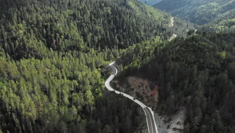 drone video following tracking car high altitude mountain forest winding road gramos