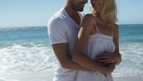 couple hugging on the beach