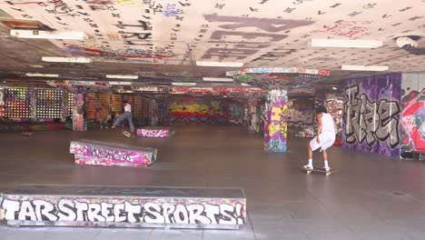 skateboarder performing tricks in urban skatepark