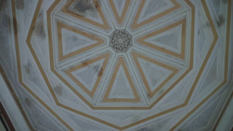 historical building with artistic structure, patterns looking up to the ceiling rotating camera movement.