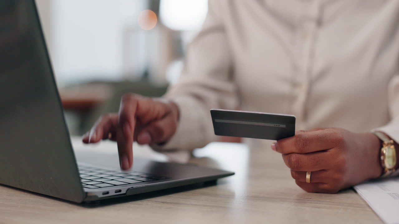Woman using credit card for online shopping on laptop