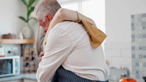 senior couple dancing and embracing in kitchen