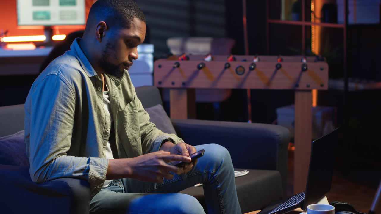 Vertical Video Black freelancer sitting on sofa and reading some papers to do research