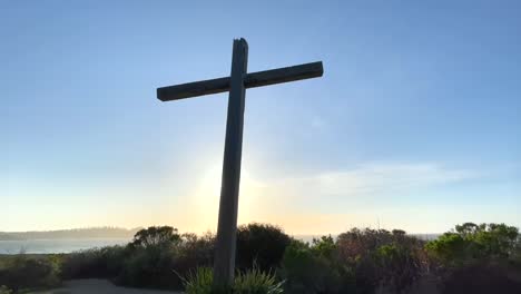 a wooden cross on a hill