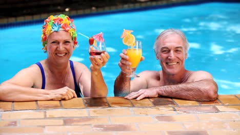 happy old couple relaxing in the swimming pool