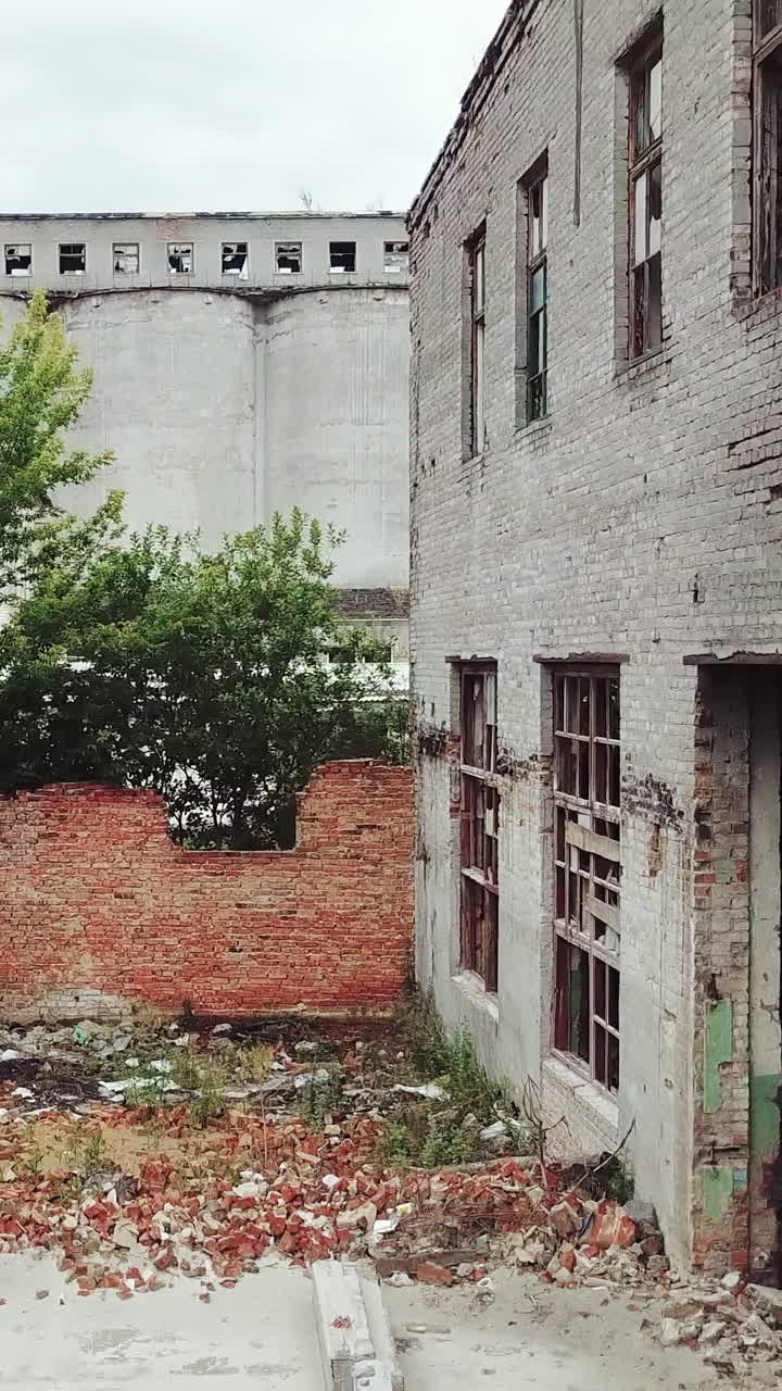 Ruins of an old factory. Old industrial building for demolition. Aerial view. Vertical video