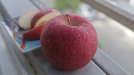 fresh red apple sliced on a window