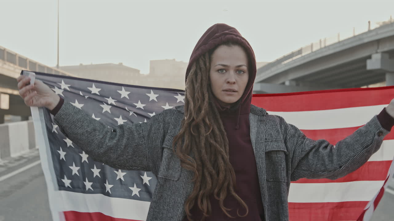 Woman with American Flag on an Empty Road