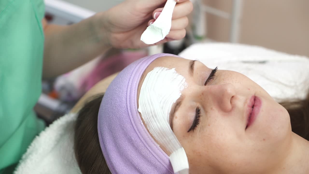 Woman with cosmetic mask. Beautiful girl with cosmetic mask on face