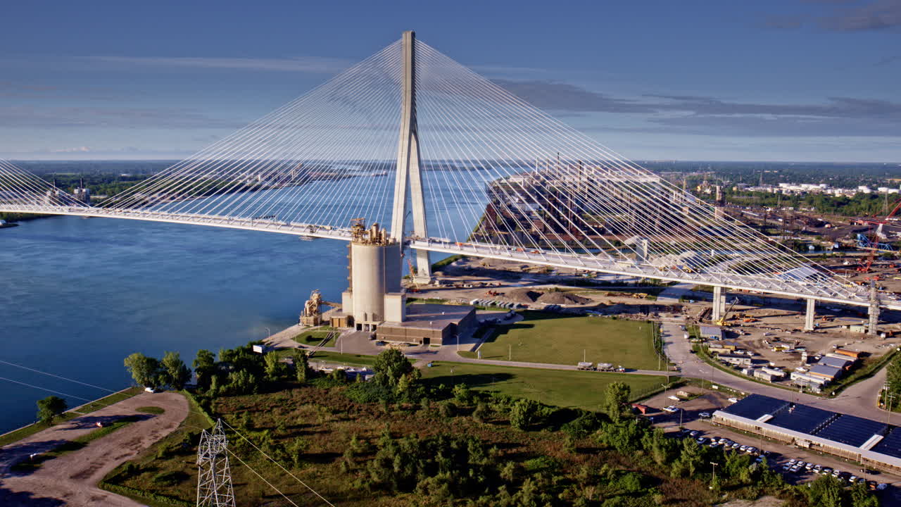 Aerial view of the new Gordie Howe International Bridge heading toward the industrial zone by the Detroit River