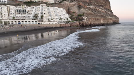 Aerial-shot-on-the-shore-of-the-Taurito-beach-in-Mogan-and-where-people-can-be-seen-bathing