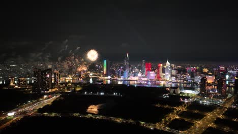 aerial view of fireworks show over skyline of ho chi minh city during the 50th reunification day in vietnam.