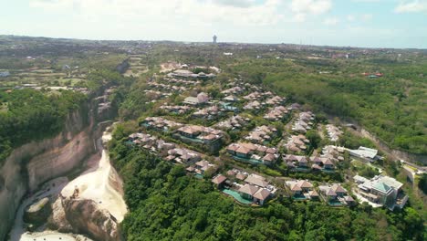 Residential-and-Rental-Luxury-Villas-with-Private-Pools-on-Top-of-Uluwatu-Cliff-in-Bali-Indonesia---Aerial-High-Up-Orbiting