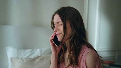 upset woman answering mobile phone at night closeup. unhappy sad girl crying