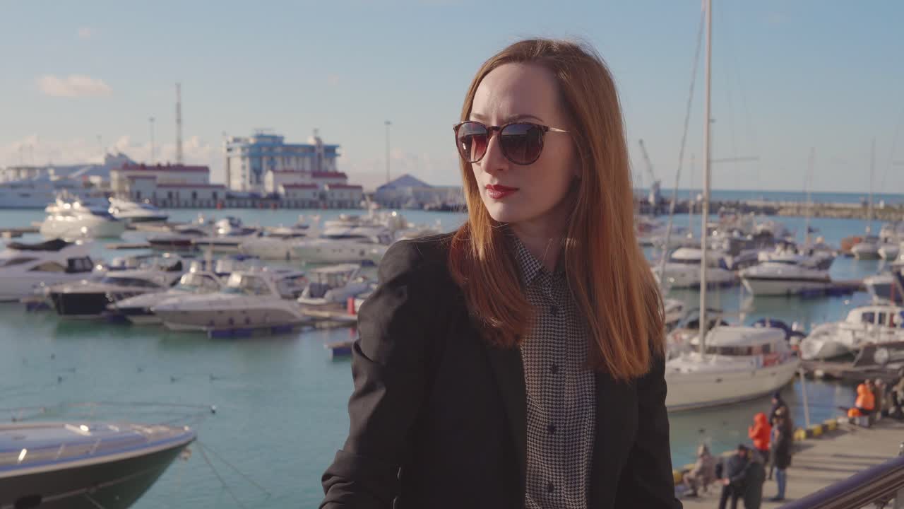 Woman in sunglasses at a marina
