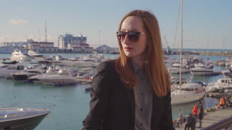 woman in sunglasses at a marina