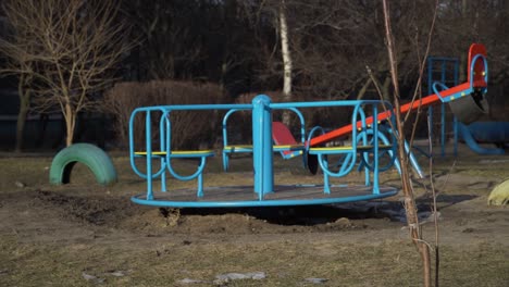 Empty Swing is Spinning on the Playground in the Yard