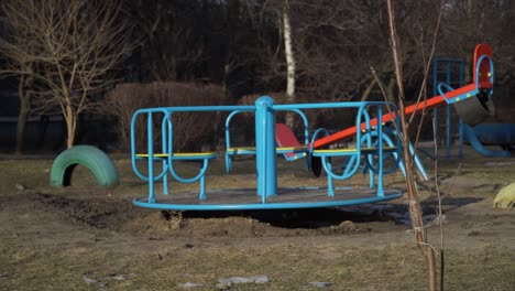 empty swing is spinning on the playground in the yard