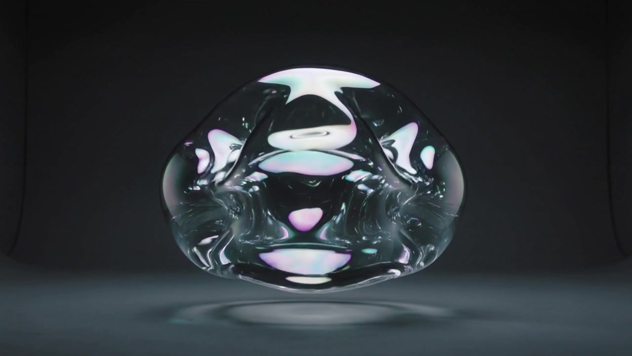 Overhead lights shifting, transparent orb deforming, hovering above matte floor in studio for study