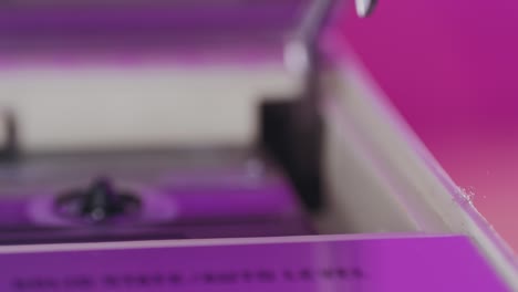 finger loading a cassette tape