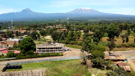 Aerial-drone-view-Open-Air-market-in-the-Loitokitok-town,-Kenya-and-mount-Kilimanjaro--Rural-village-of-Kenya