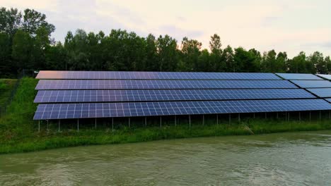 Captivating-aerial-4K-drone-footage-of-a-solar-panel-plant-nestled-alongside-the-Drava-river-in-Slovenia