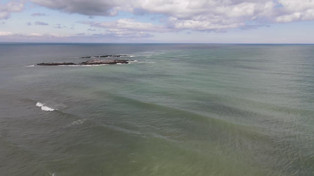 toma de drone de una casa en una isla frente a la playa de black rock en cohasset, mamá.