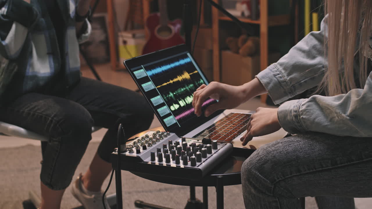 Two Girls Recording Music In Studio