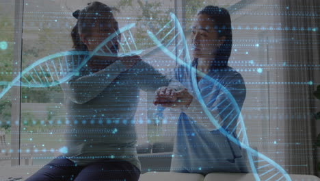 animation of dna strand and medical data processing over diverse female physiotherapist and patient