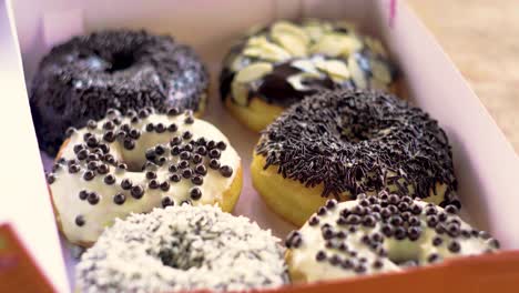 Focus-slide-on-the-box-full-of-delicious-donuts