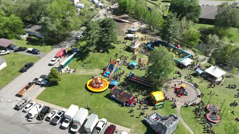 hyperlapse aerial orbit of dogwood festival kids park bounce castle and attractions, siloam springs, arkansas