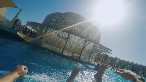 a man descends from a water slide with only feet visible 3