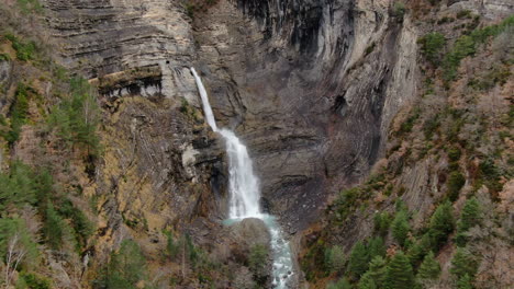 aerial-view-traveling-out-over-the-Sorrosal-waterfall-in-the-province-of-Huesca,-Aragon,-on-a-sunny-day