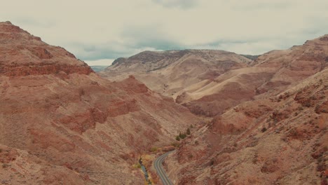 4k aerial red canyon with country road in the middle drone wild shot